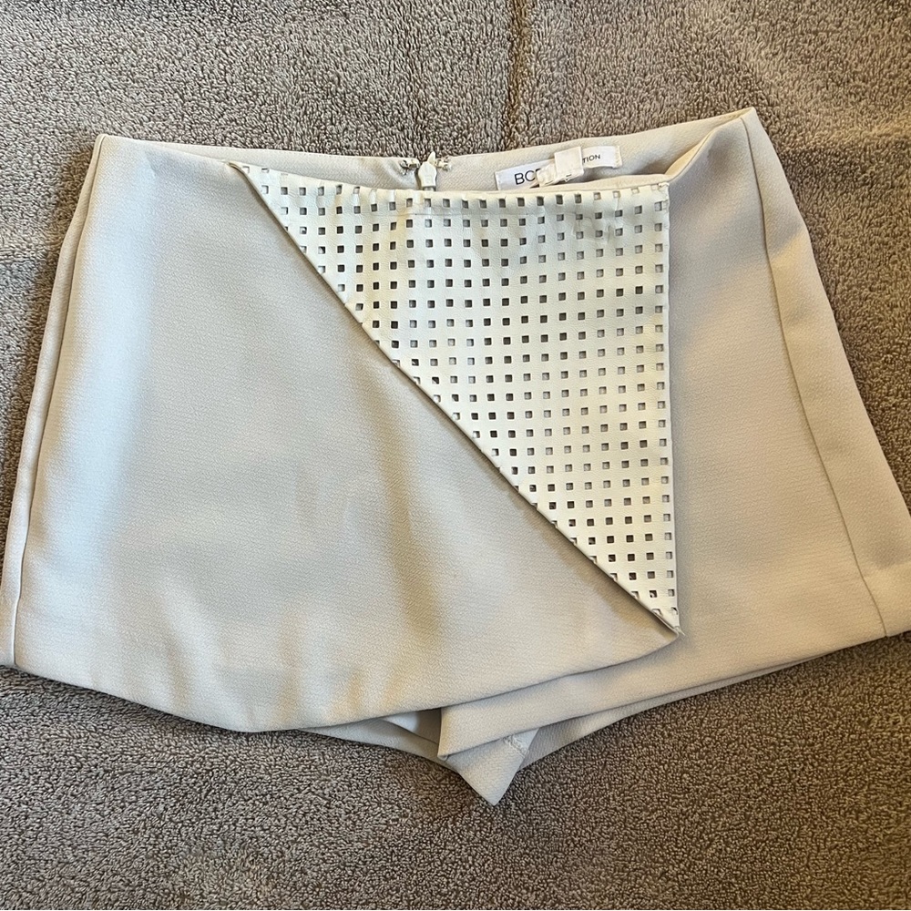 Cream colored BCBGeneration skort with leather fold over detail